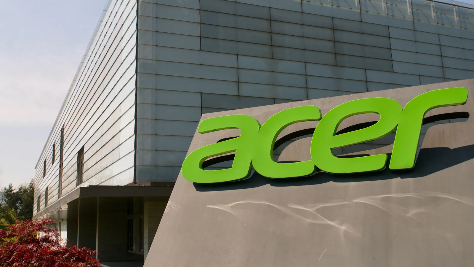Logo dan perangkat komputer Acer sebagai ilustrasi profil perusahaan teknologi global